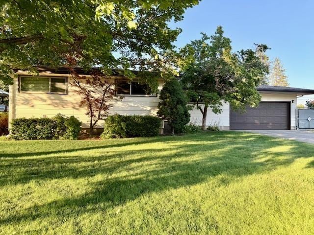 6412 N Fotheringham St, Spokane, WA 99208 - view of front of home with a front yard, an attached garage, and driveway