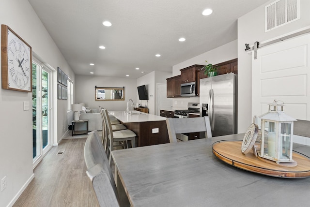 1225 E Paske Rd, Colbert, WA 99005 - dining area with light wood-style floors, recessed lighting, and a barn door