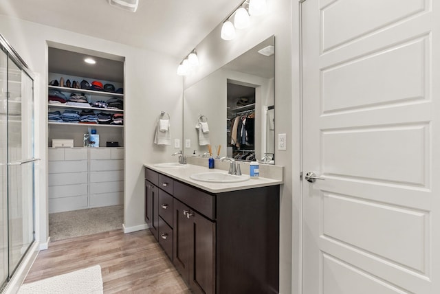 1225 E Paske Rd, Colbert, WA 99005 - bathroom with double vanity, wood finished floors, a spacious closet, and a stall shower