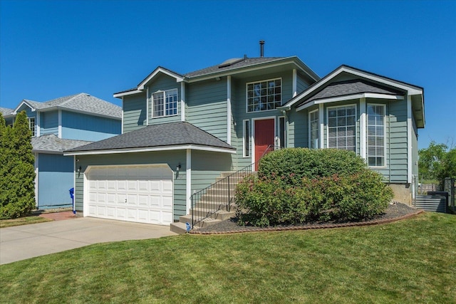 4407 E 14th Ave, Spokane, WA 99212 - traditional home with driveway, a front yard, and an attached garage