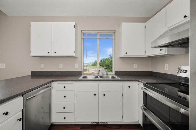 4407 E 14th Ave, Spokane, WA 99212 - kitchen with appliances with stainless steel finishes, ventilation hood, dark countertops, and white cabinetry