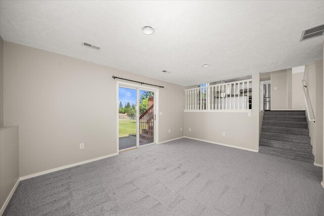 4407 E 14th Ave, Spokane, WA 99212 - spare room featuring carpet floors, stairway, and recessed lighting