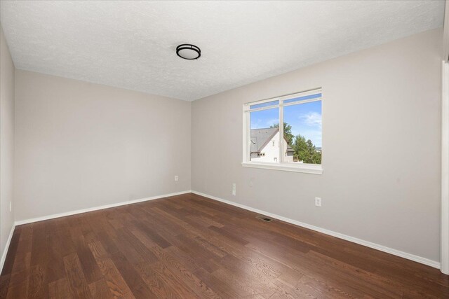 4407 E 14th Ave, Spokane, WA 99212 - unfurnished room featuring dark wood-style floors and a textured ceiling