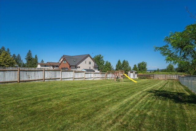 4407 E 14th Ave, Spokane, WA 99212 - fenced backyard with a playground and a shed