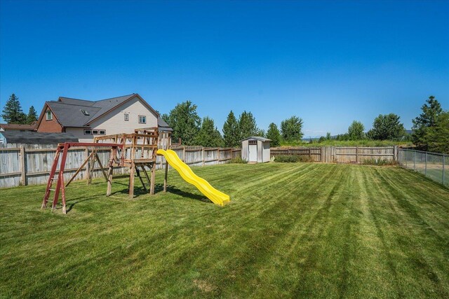 4407 E 14th Ave, Spokane, WA 99212 - fenced backyard featuring a storage unit and a playground