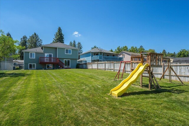 4407 E 14th Ave, Spokane, WA 99212 - fenced backyard featuring a playground, a deck, stairs, and a residential view
