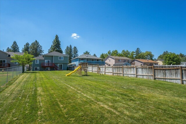 4407 E 14th Ave, Spokane, WA 99212 - fenced backyard with a playground, a residential view, and a water view