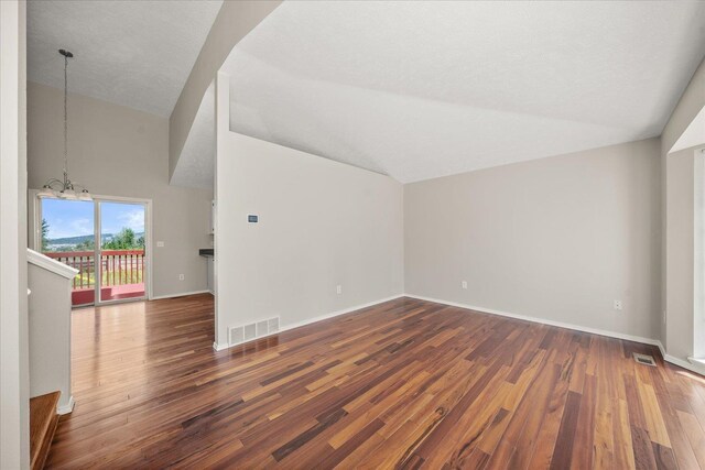 4407 E 14th Ave, Spokane, WA 99212 - bonus room featuring dark wood finished floors, a chandelier, and high vaulted ceiling