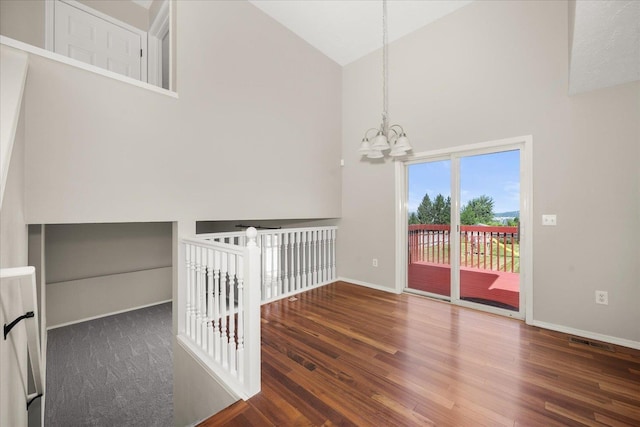 4407 E 14th Ave, Spokane, WA 99212 - spare room with high vaulted ceiling, a chandelier, and wood finished floors
