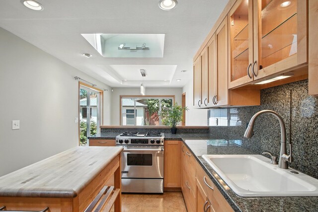 3121 S Manito Blvd, Spokane, WA 99203 - kitchen with stainless steel gas range oven, decorative backsplash, glass insert cabinets, recessed lighting, and a tray ceiling