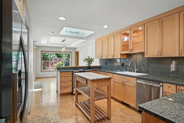 3121 S Manito Blvd, Spokane, WA 99203 - kitchen with appliances with stainless steel finishes, a peninsula, tasteful backsplash, a skylight, and recessed lighting