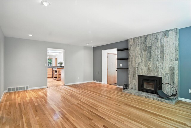 3121 S Manito Blvd, Spokane, WA 99203 - unfurnished living room featuring a large fireplace, wood finished floors, and recessed lighting