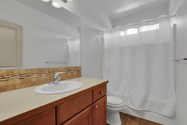 8812 W Pirates Ct, Spokane, WA 99224 - full bath with vanity, wood finished floors, backsplash, and shower / tub combo