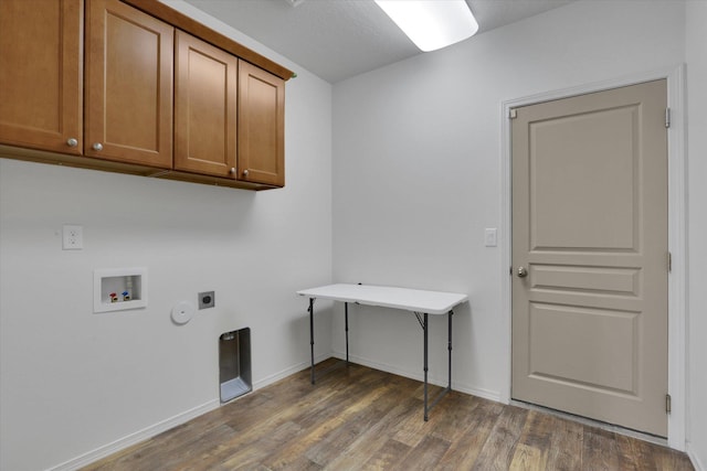 8812 W Pirates Ct, Spokane, WA 99224 - laundry room with cabinet space, electric dryer hookup, hookup for a washing machine, dark wood-style floors, and hookup for a gas dryer