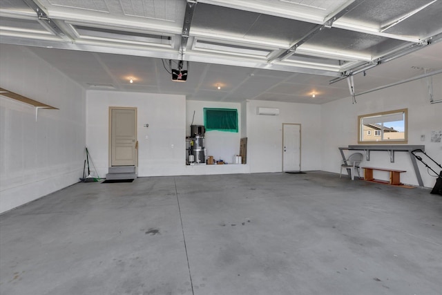 8812 W Pirates Ct, Spokane, WA 99224 - garage with a garage door opener and a wall mounted air conditioner