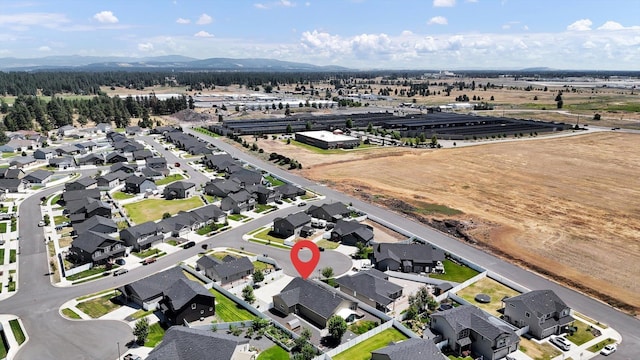 8812 W Pirates Ct, Spokane, WA 99224 - aerial overview of property's location with nearby suburban area and a mountainous background