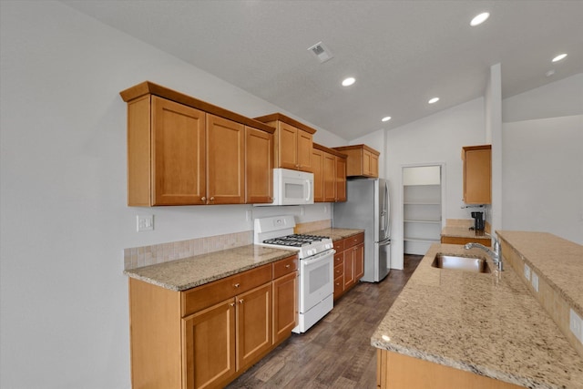 8812 W Pirates Ct, Spokane, WA 99224 - kitchen featuring white appliances, lofted ceiling, dark wood finished floors, recessed lighting, and light stone countertops