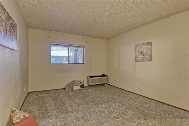 707 W 6th Ave Unit 44, Spokane, WA 99204 - carpeted spare room featuring a wall mounted air conditioner and a textured ceiling