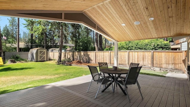811 W Teal Ave, Spokane, WA 99218 - deck featuring outdoor dining space, a fenced backyard, and a storage shed