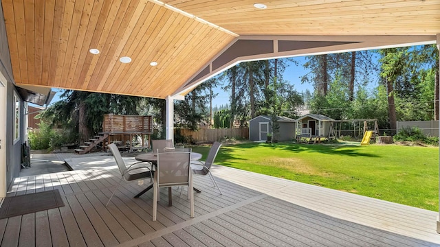 811 W Teal Ave, Spokane, WA 99218 - deck featuring a shed, outdoor dining space, a playground, a fenced backyard, and stairway