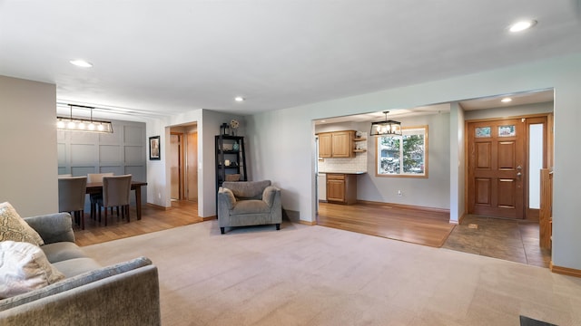 811 W Teal Ave, Spokane, WA 99218 - living room featuring light colored carpet, recessed lighting, a chandelier, and light wood-style flooring