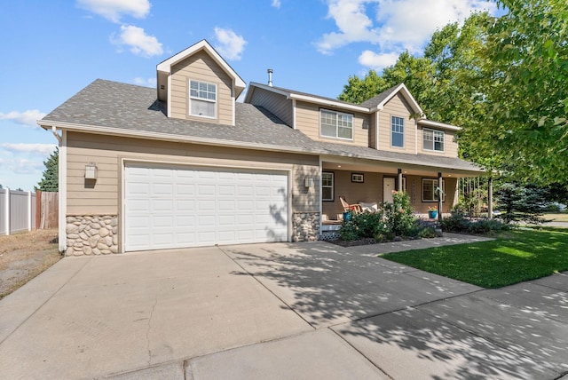 3421 S Mcdonald St, Spokane Valley, WA 99206 - view of front of home featuring covered porch, stone siding, driveway, an attached garage, and roof with shingles