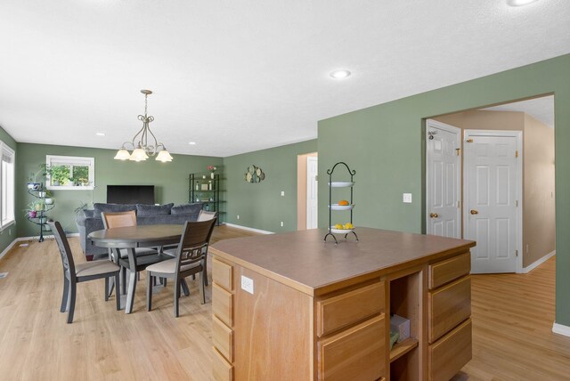 3421 S Mcdonald St, Spokane Valley, WA 99206 - kitchen featuring a center island, light wood-style floors, recessed lighting, decorative light fixtures, and open floor plan
