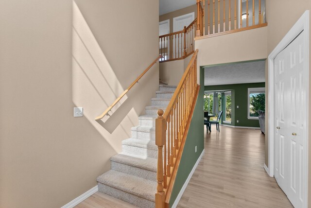 3421 S Mcdonald St, Spokane Valley, WA 99206 - staircase featuring wood finished floors and a high ceiling