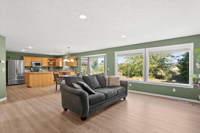 3421 S Mcdonald St, Spokane Valley, WA 99206 - living area featuring light wood finished floors, a chandelier, recessed lighting, and a textured ceiling