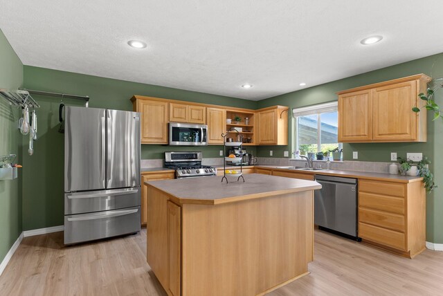 3421 S Mcdonald St, Spokane Valley, WA 99206 - kitchen with stainless steel appliances, light wood-type flooring, a kitchen island, open shelves, and recessed lighting