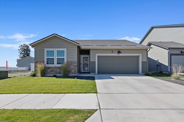 8403 W Red Ave, Cheney, WA 99004 - view of front of home with a garage, driveway, a front lawn, and stone siding