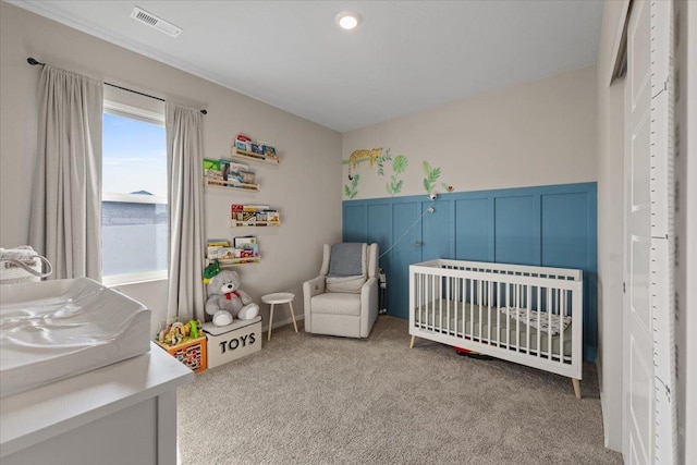 8403 W Red Ave, Cheney, WA 99004 - carpeted bedroom featuring a nursery area and a wainscoted wall