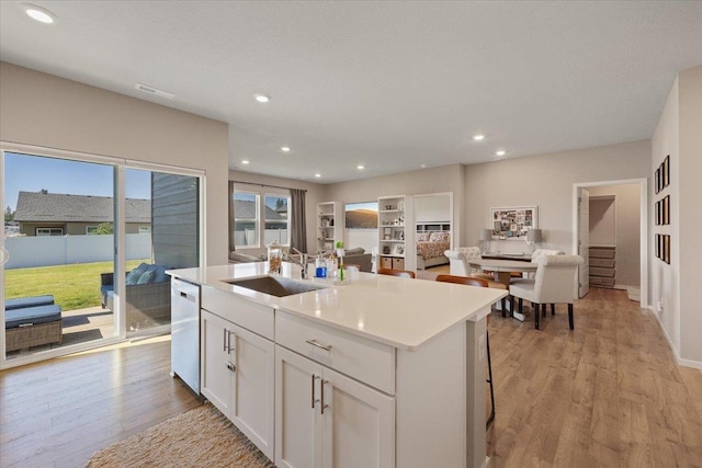 8403 W Red Ave, Cheney, WA 99004 - kitchen featuring light wood-type flooring, white cabinetry, a center island with sink, dishwasher, and recessed lighting