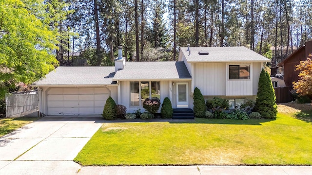 5623 W Lyons Ct, Spokane, WA 99208 - tri-level home featuring an attached garage, a chimney, driveway, and a shingled roof
