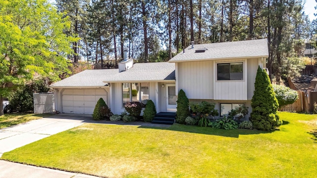 5623 W Lyons Ct, Spokane, WA 99208 - tri-level home featuring a garage, driveway, a chimney, and a shingled roof