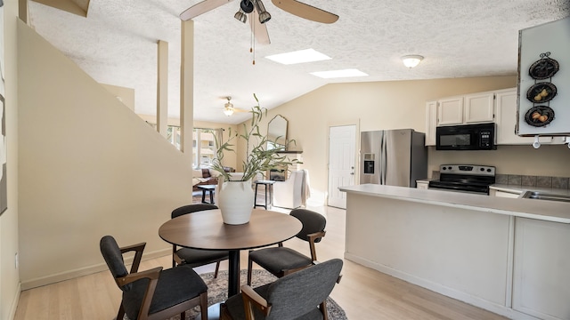 5623 W Lyons Ct, Spokane, WA 99208 - dining area featuring ceiling fan, light wood-style flooring, a textured ceiling, and vaulted ceiling