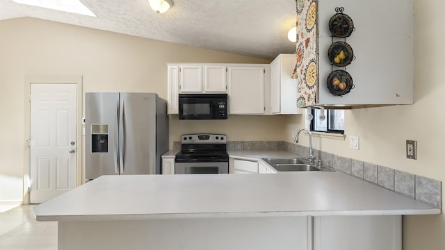 5623 W Lyons Ct, Spokane, WA 99208 - kitchen featuring stainless steel appliances, vaulted ceiling, a peninsula, light countertops, and white cabinetry