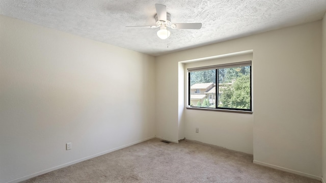 5623 W Lyons Ct, Spokane, WA 99208 - unfurnished room with light carpet, ceiling fan, and a textured ceiling