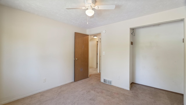 5623 W Lyons Ct, Spokane, WA 99208 - unfurnished bedroom featuring light colored carpet, a closet, a textured ceiling, and a ceiling fan