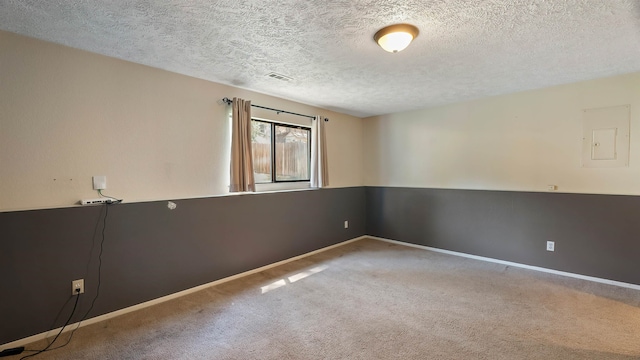 5623 W Lyons Ct, Spokane, WA 99208 - unfurnished room featuring carpet, electric panel, and a textured ceiling