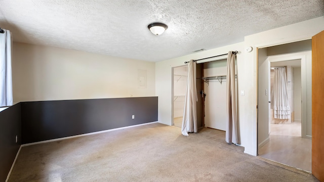 5623 W Lyons Ct, Spokane, WA 99208 - unfurnished bedroom featuring carpet, a closet, and a textured ceiling