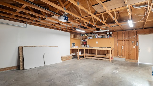 5623 W Lyons Ct, Spokane, WA 99208 - garage featuring a workshop area and a garage door opener