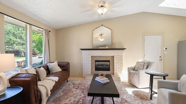 5623 W Lyons Ct, Spokane, WA 99208 - living area with lofted ceiling, a ceiling fan, and a brick fireplace