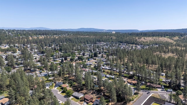 5623 W Lyons Ct, Spokane, WA 99208 - aerial view of property's location with a heavily wooded area and a mountainous background