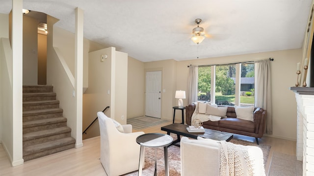5623 W Lyons Ct, Spokane, WA 99208 - living room featuring ceiling fan, stairs, and light wood-type flooring