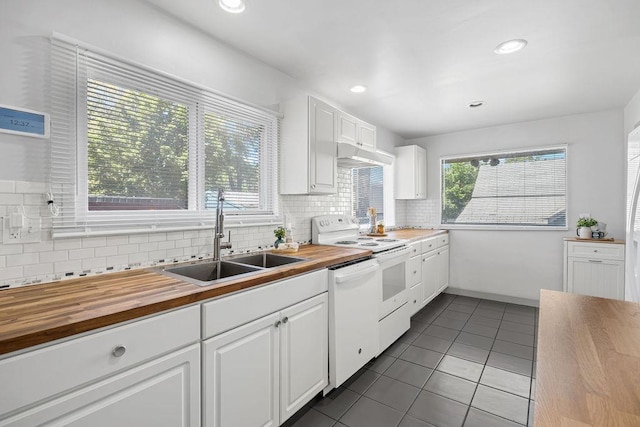 3129 E 34th Ave, Spokane, WA 99223 - kitchen with butcher block counters, white appliances, under cabinet range hood, dark tile patterned flooring, and recessed lighting