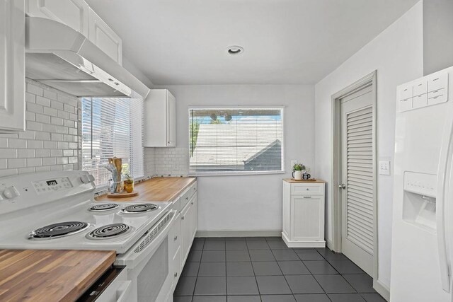 3129 E 34th Ave, Spokane, WA 99223 - kitchen with white appliances, under cabinet range hood, butcher block countertops, and dark tile patterned flooring