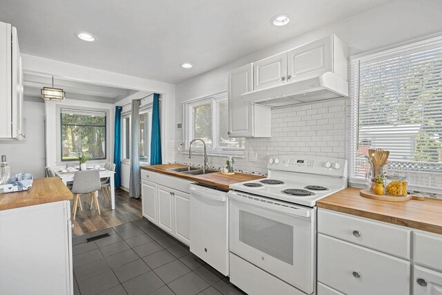 3129 E 34th Ave, Spokane, WA 99223 - kitchen featuring butcher block counters, white appliances, under cabinet range hood, white cabinetry, and tasteful backsplash