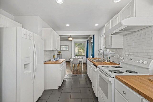 3129 E 34th Ave, Spokane, WA 99223 - kitchen with white appliances, butcher block countertops, white cabinetry, tasteful backsplash, and recessed lighting