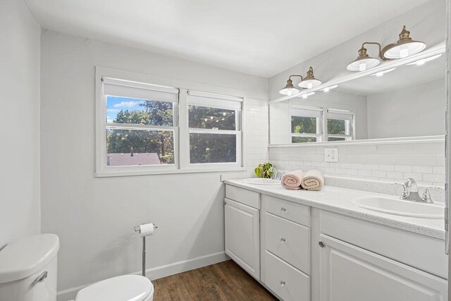 3129 E 34th Ave, Spokane, WA 99223 - bathroom with tasteful backsplash, double vanity, and wood finished floors